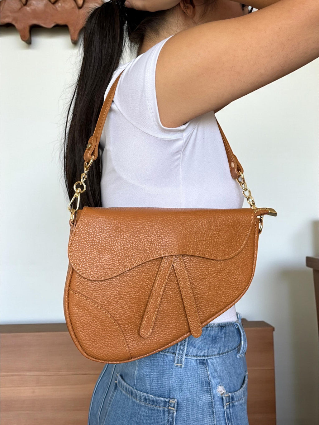 Asymmetric pebbled leather Saddle Flap Bag