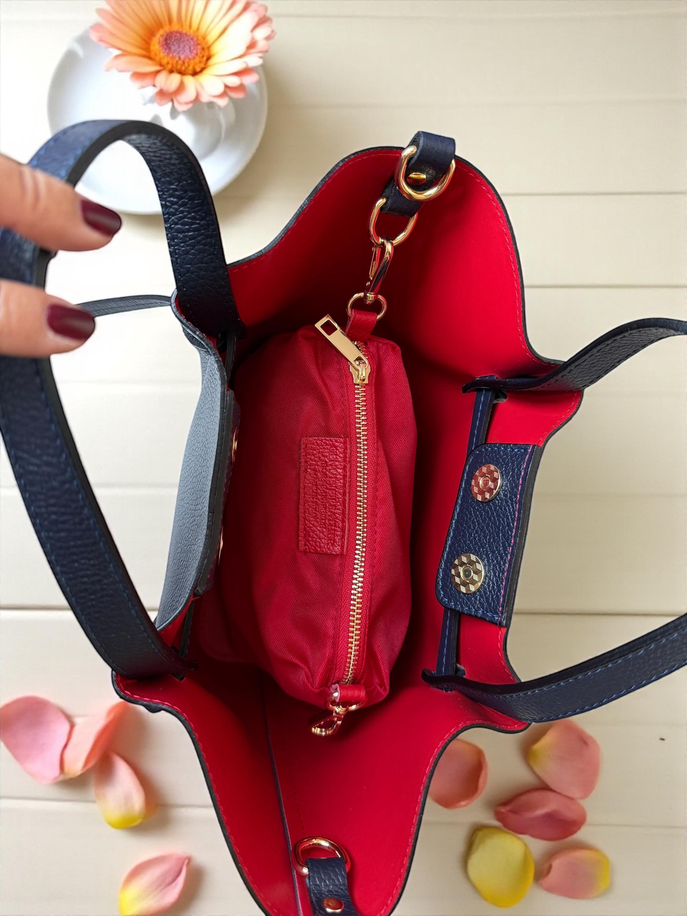 Navy leather bag with bright red interior lining and red pouch