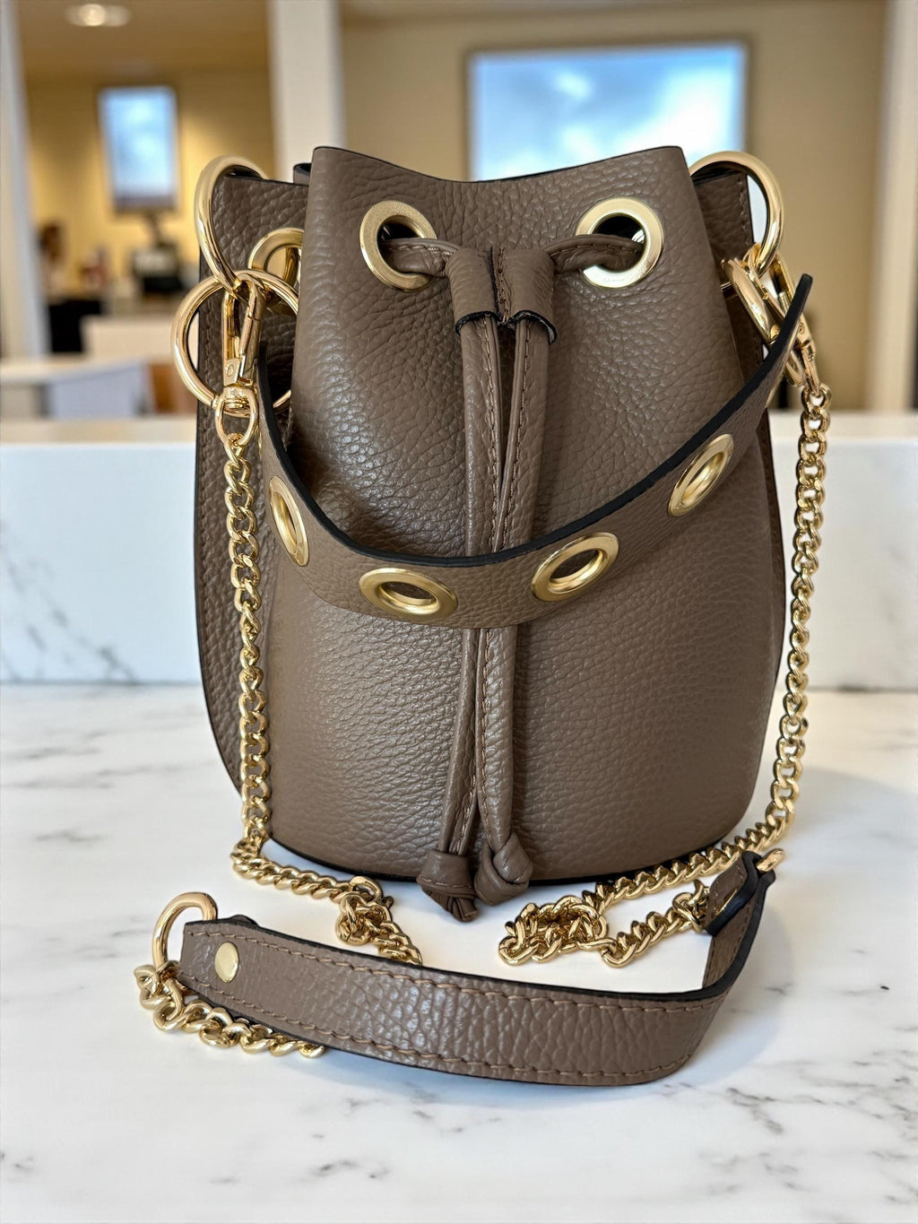 A mini bucket bag in elegant Taupe leather for day-to-night Paloma Palomo