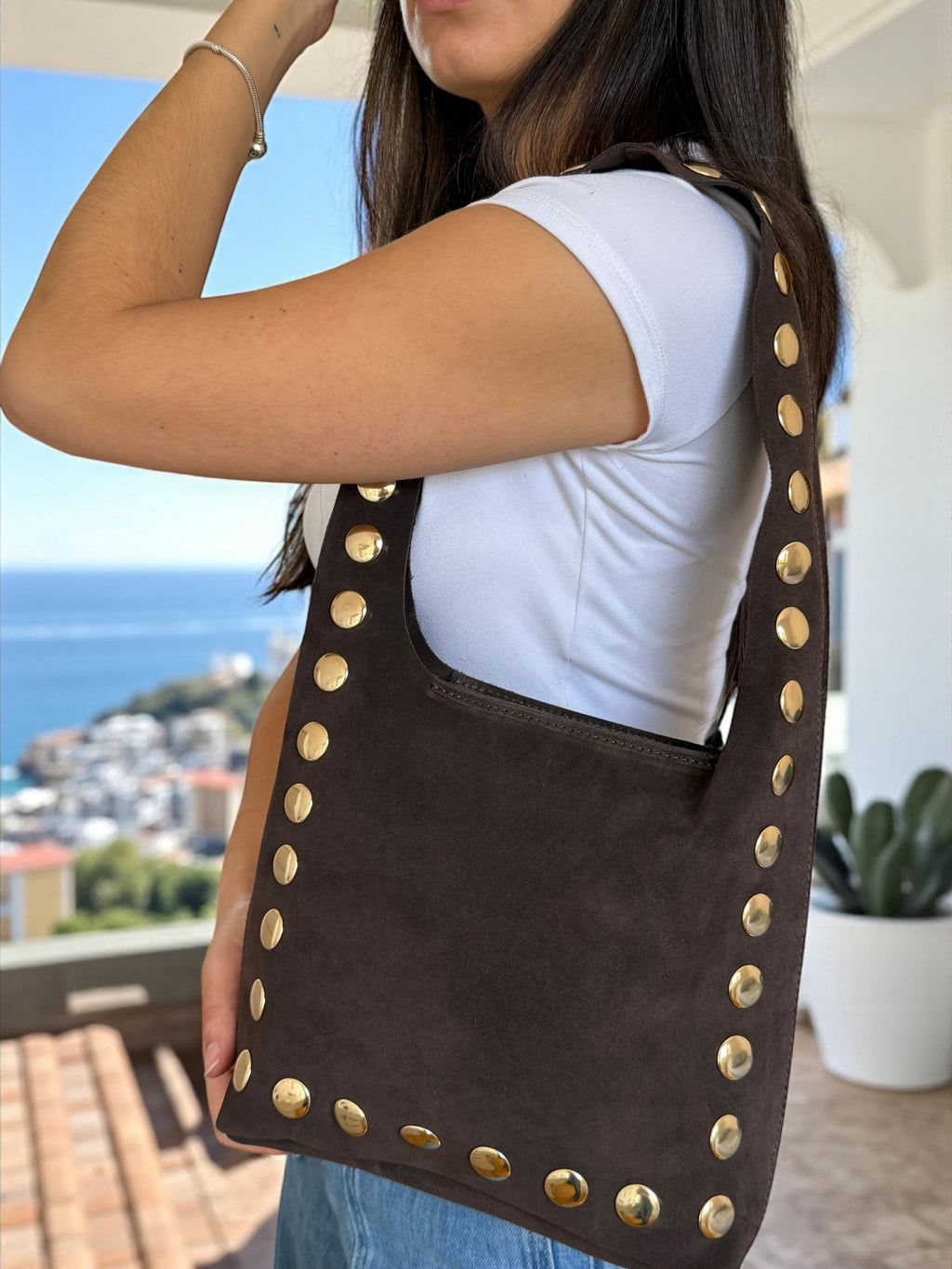 A soft suede crossbody with gold-tone studs for a touch of edge Paloma Palomo