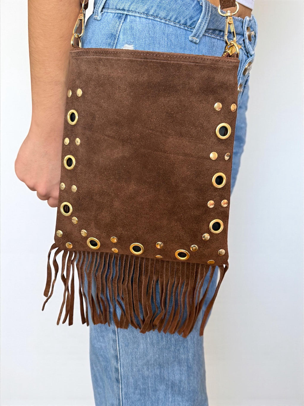 A suede studded fringe crossbody bag with a playful, boho-chic look