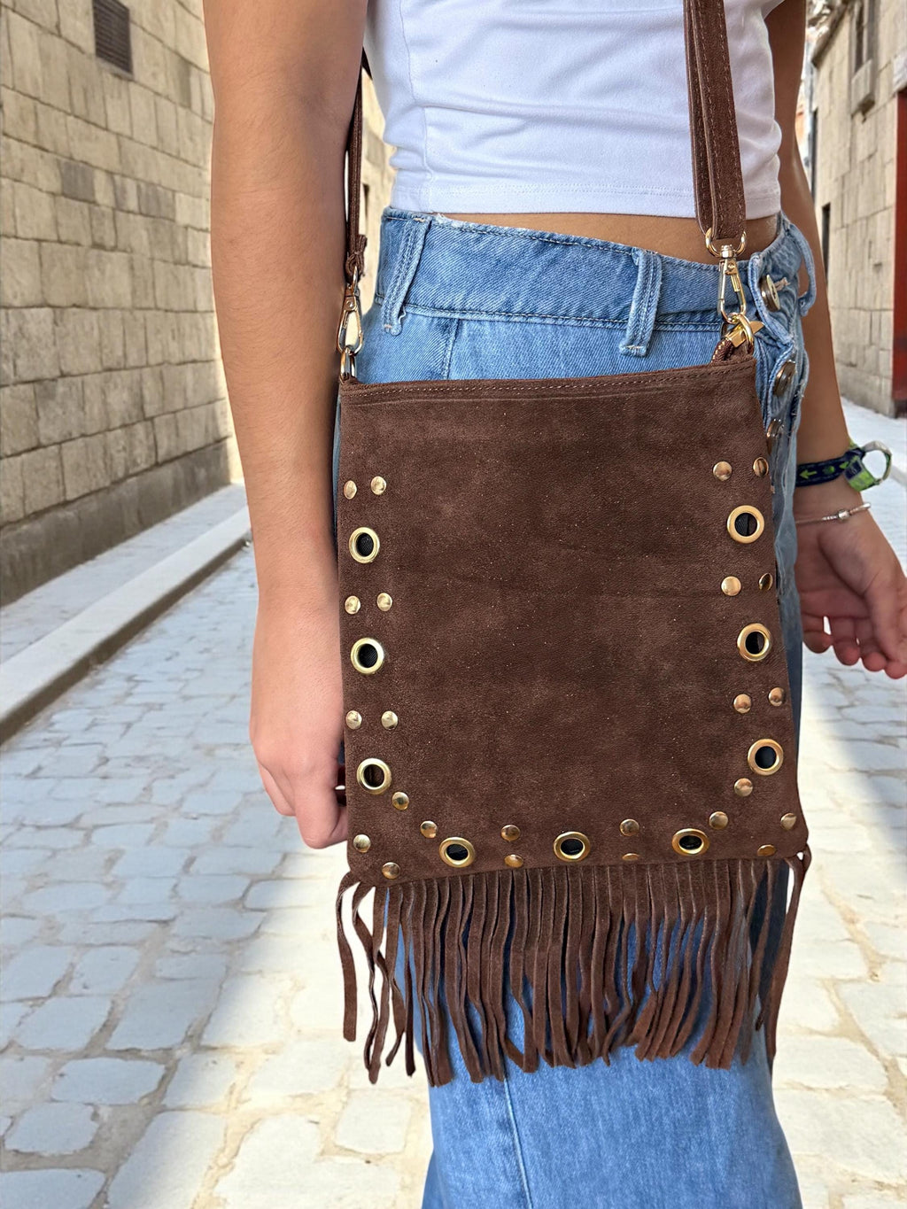 Close-up of gold-tone eyelet pattern on premium suede leather
