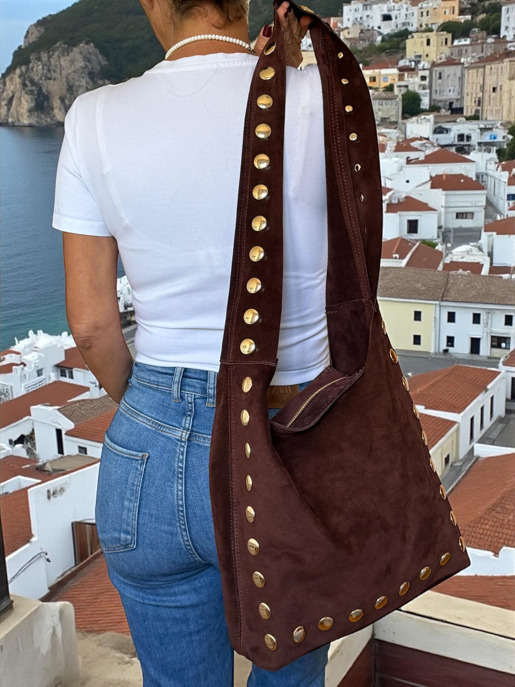 Hand-placed gold-tone studs add a bold, boho-luxe edge to the suede. Paloma Palomo