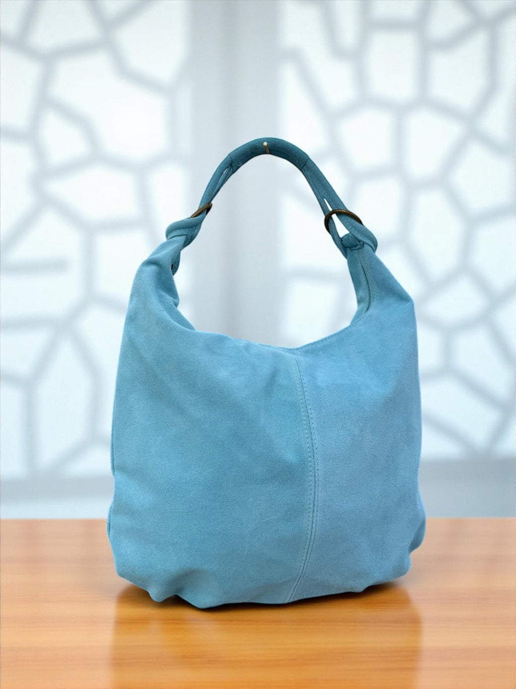A spacious suede blue light tote bag perfect for everyday use and travel