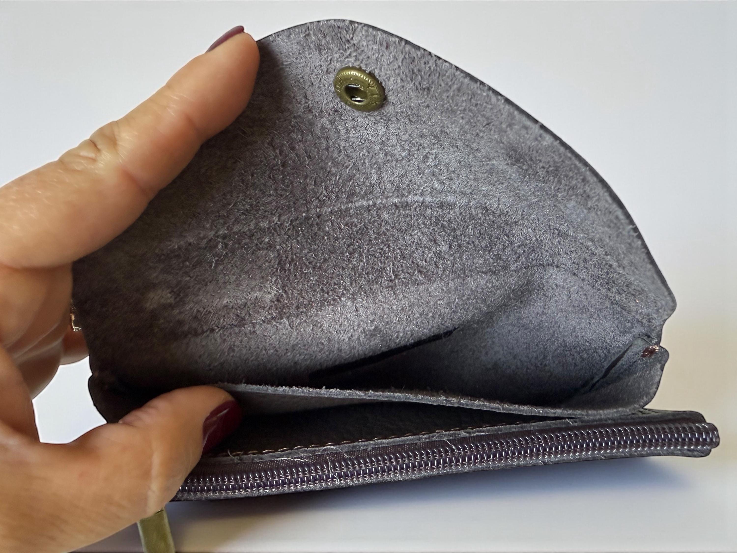Interior view of the leather wallet showing card pockets and zippered coin section