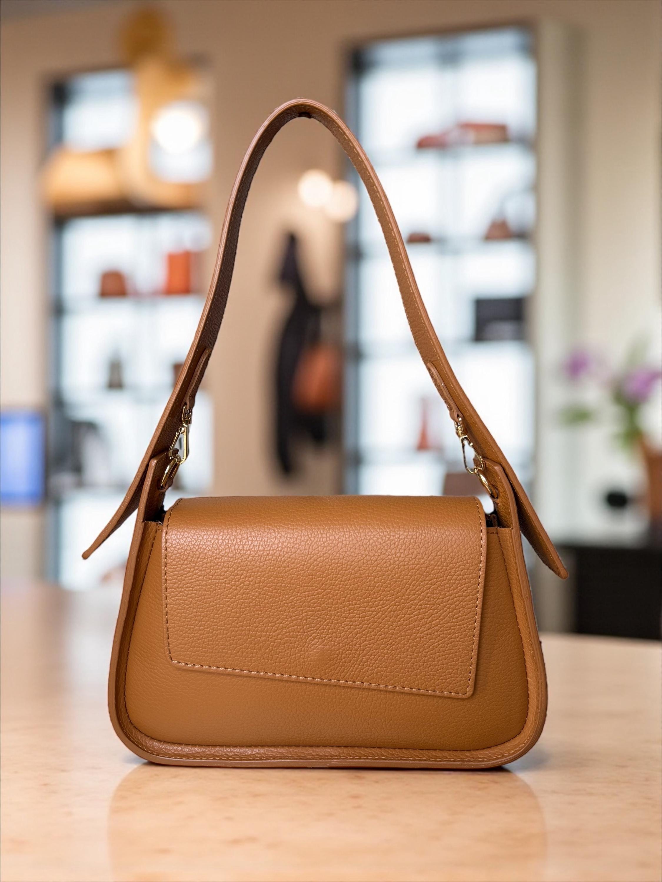 Camel tan structured leather bag with sculptural top handle