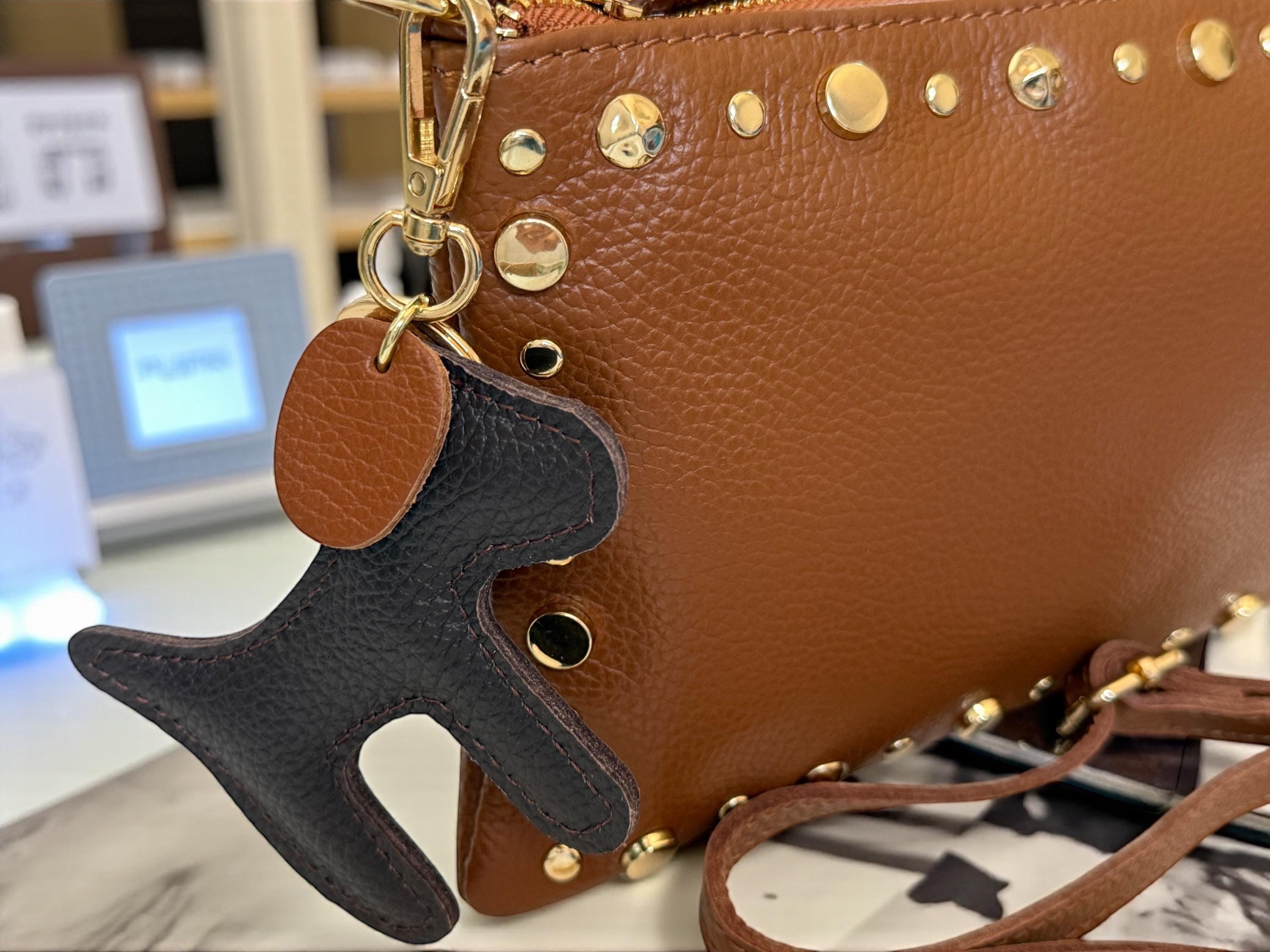 Studded leather clutch styled with a bag charm - Charm not included