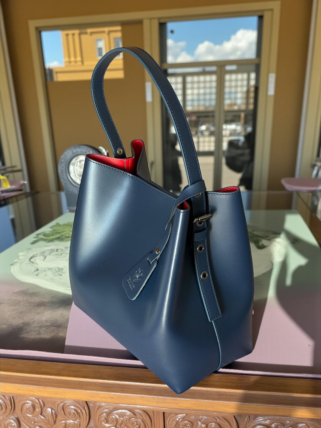 Navy blue structured vertical leather tote with red interior