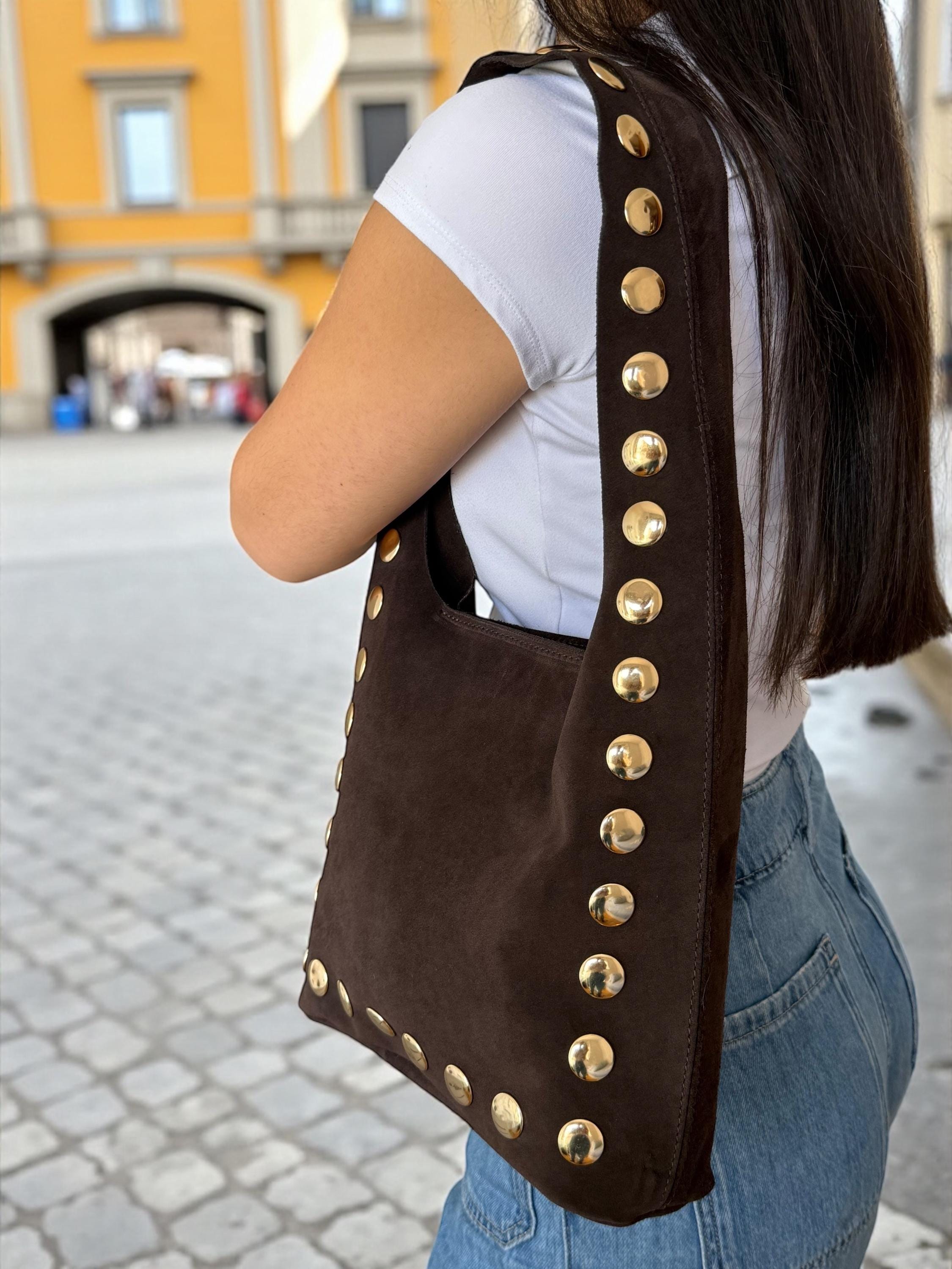Woman wearing a studded suede bag for day-to-night styling