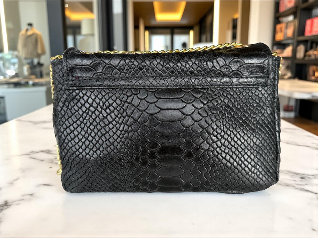 Back view of the black embossed leather evening bag showing the refined stitching