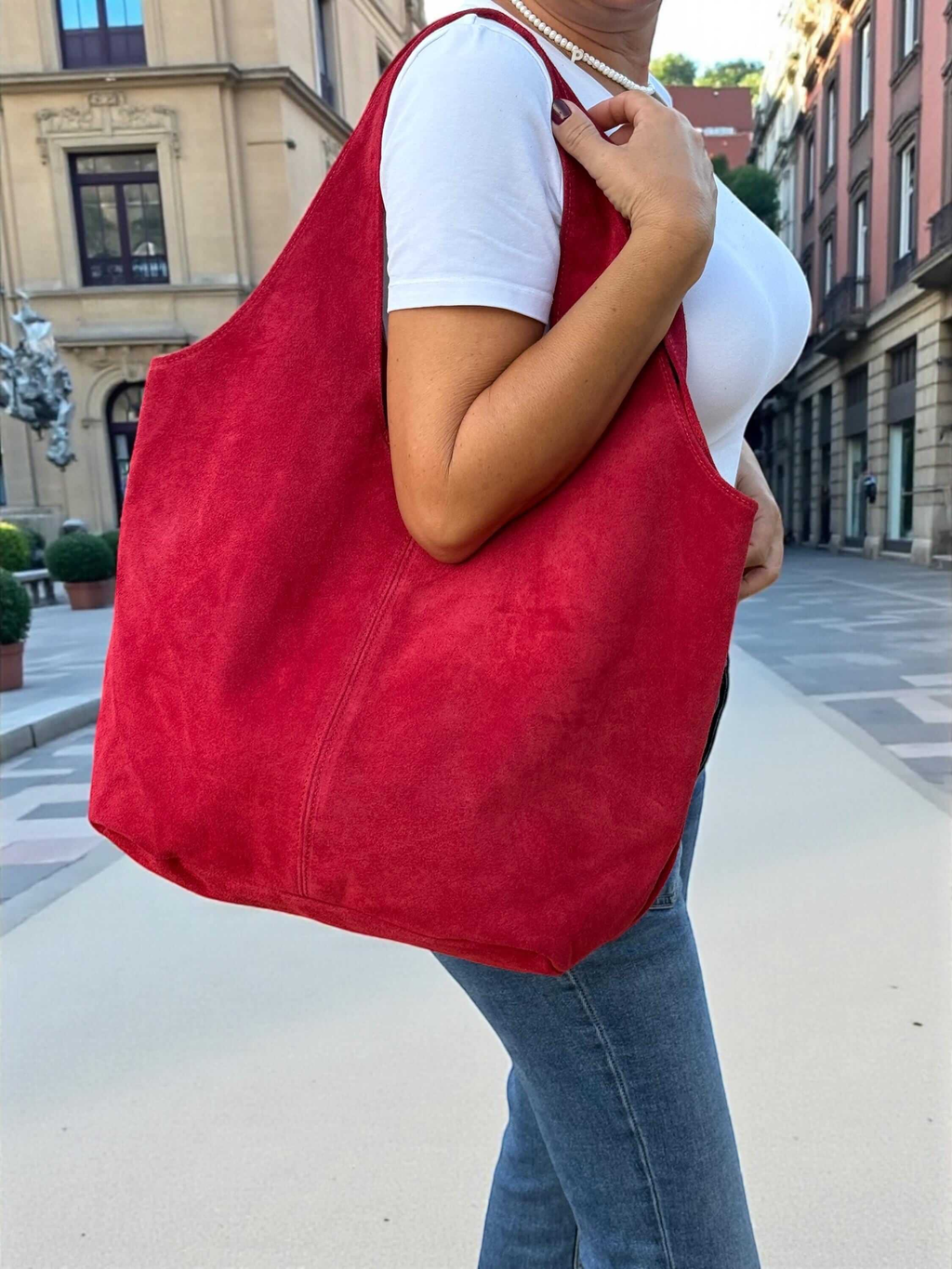 Oversized Red Suede boho Tote bag – University or office bag being carried in a stylish urban setting.