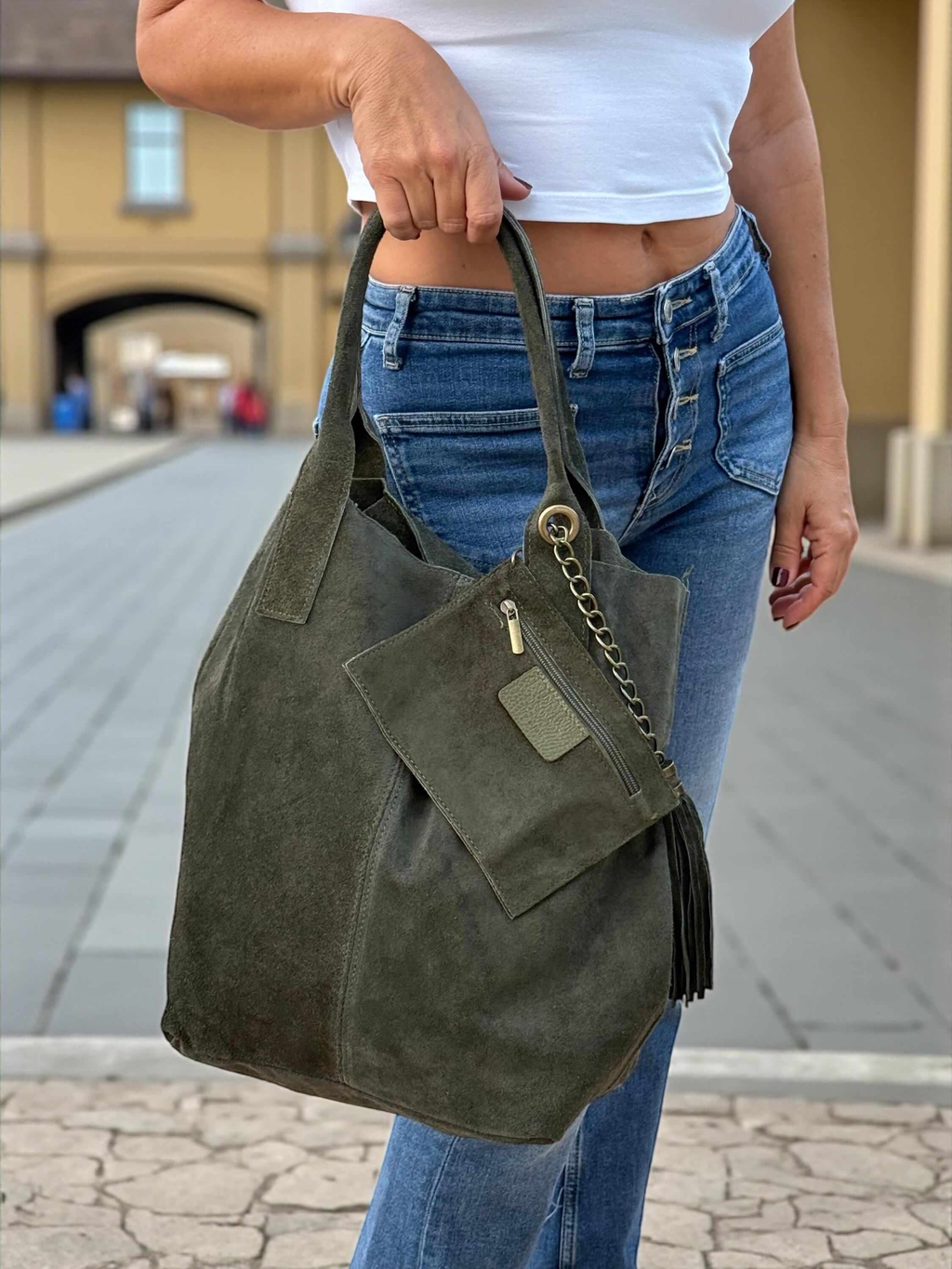 women wearing a olive green suede tote bag with tassel Paloma Palomo